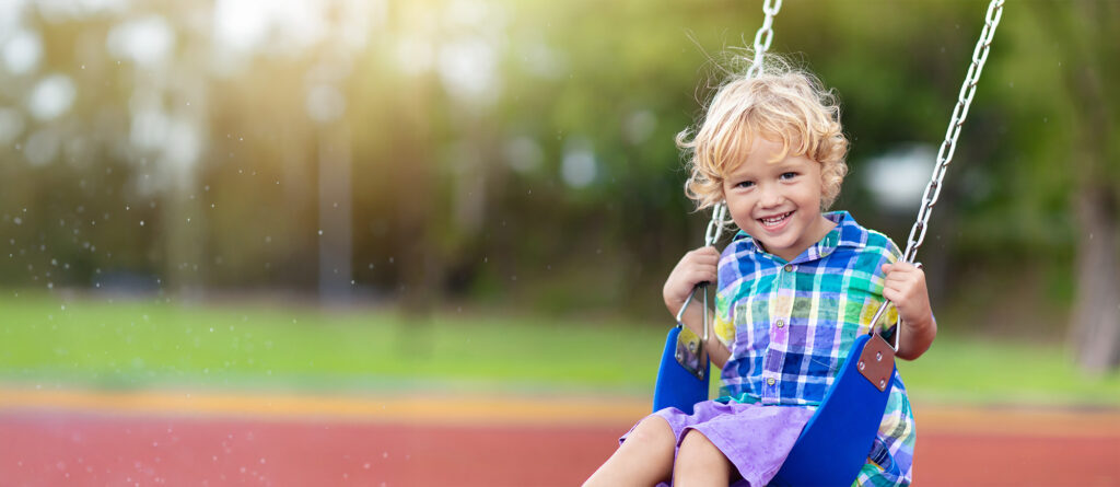 Smiling child on a swing