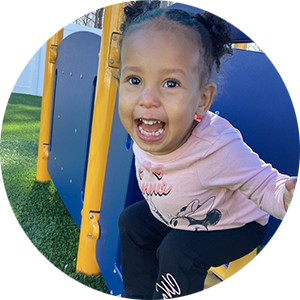 Smiling toddler playing outside