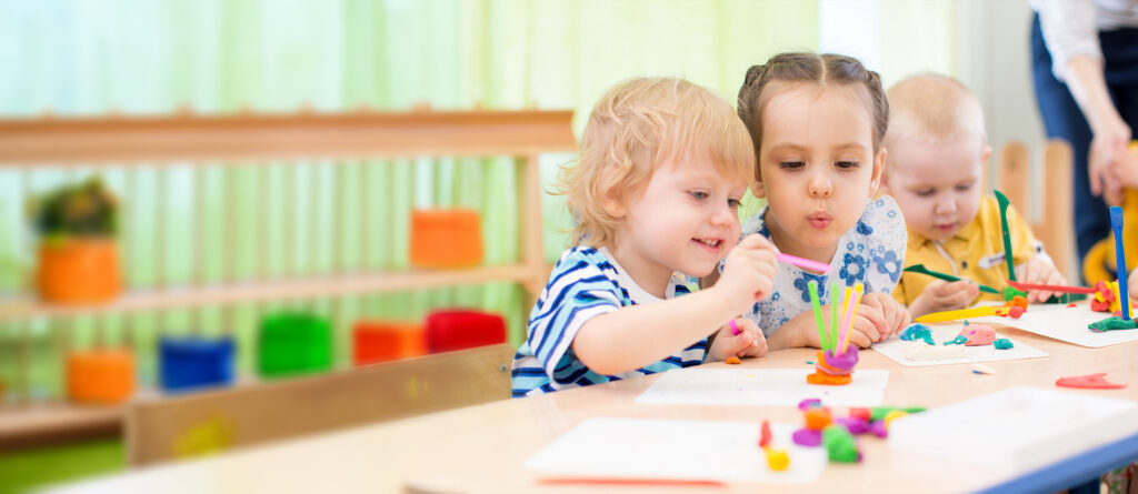 Three children making crafts at a table