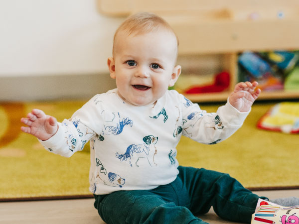 Infant child sitting on floor