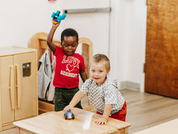 Two toddlers playing with toys