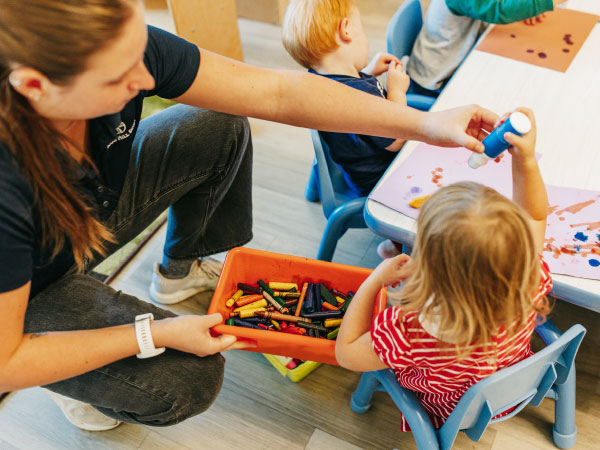 Caregiver working with two year old girl