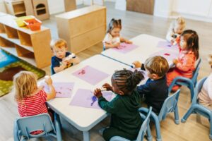 Children working on artwork at a table